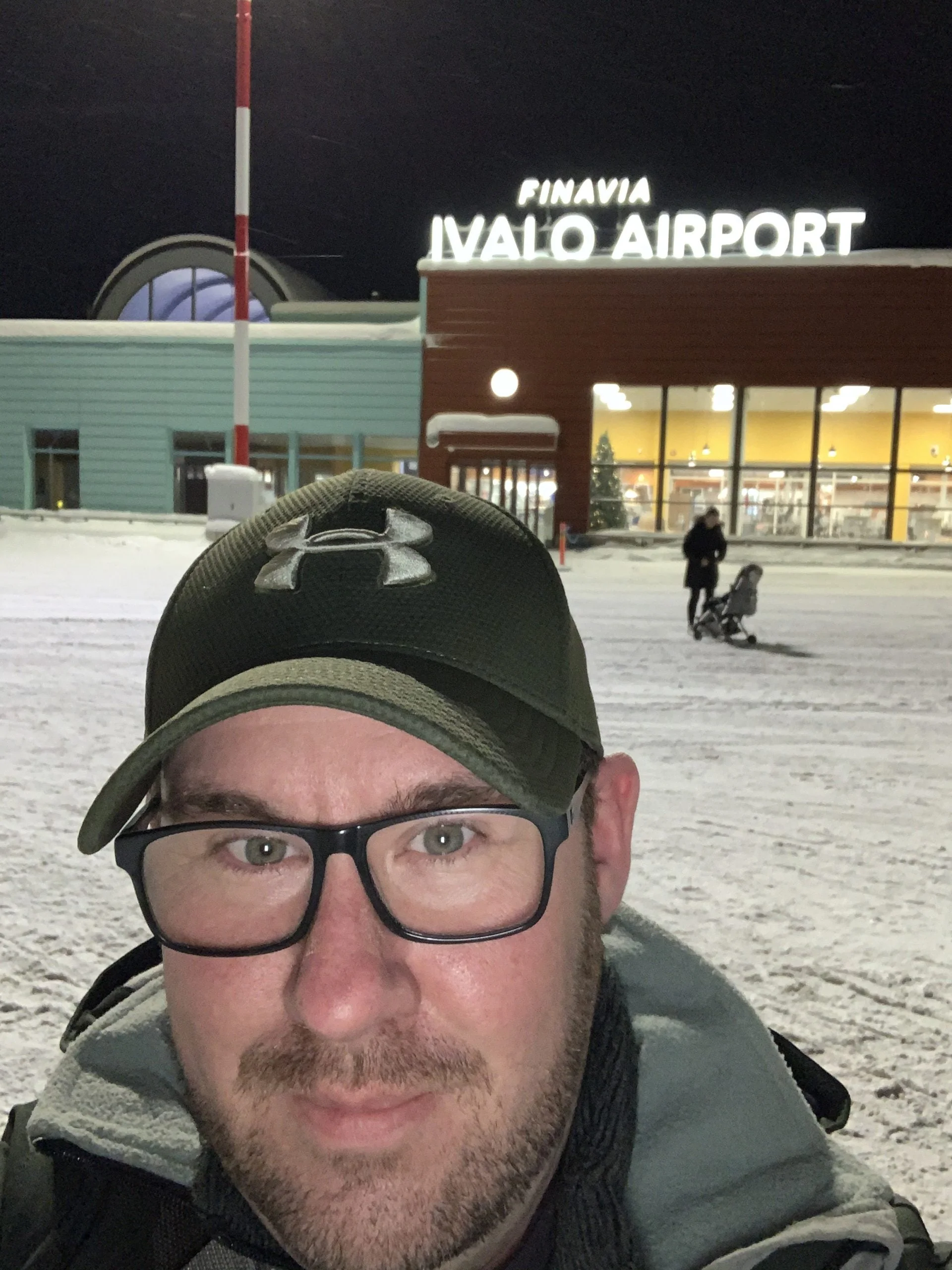 a man wearing glasses outside Finavia Ivalo Airport, Finland