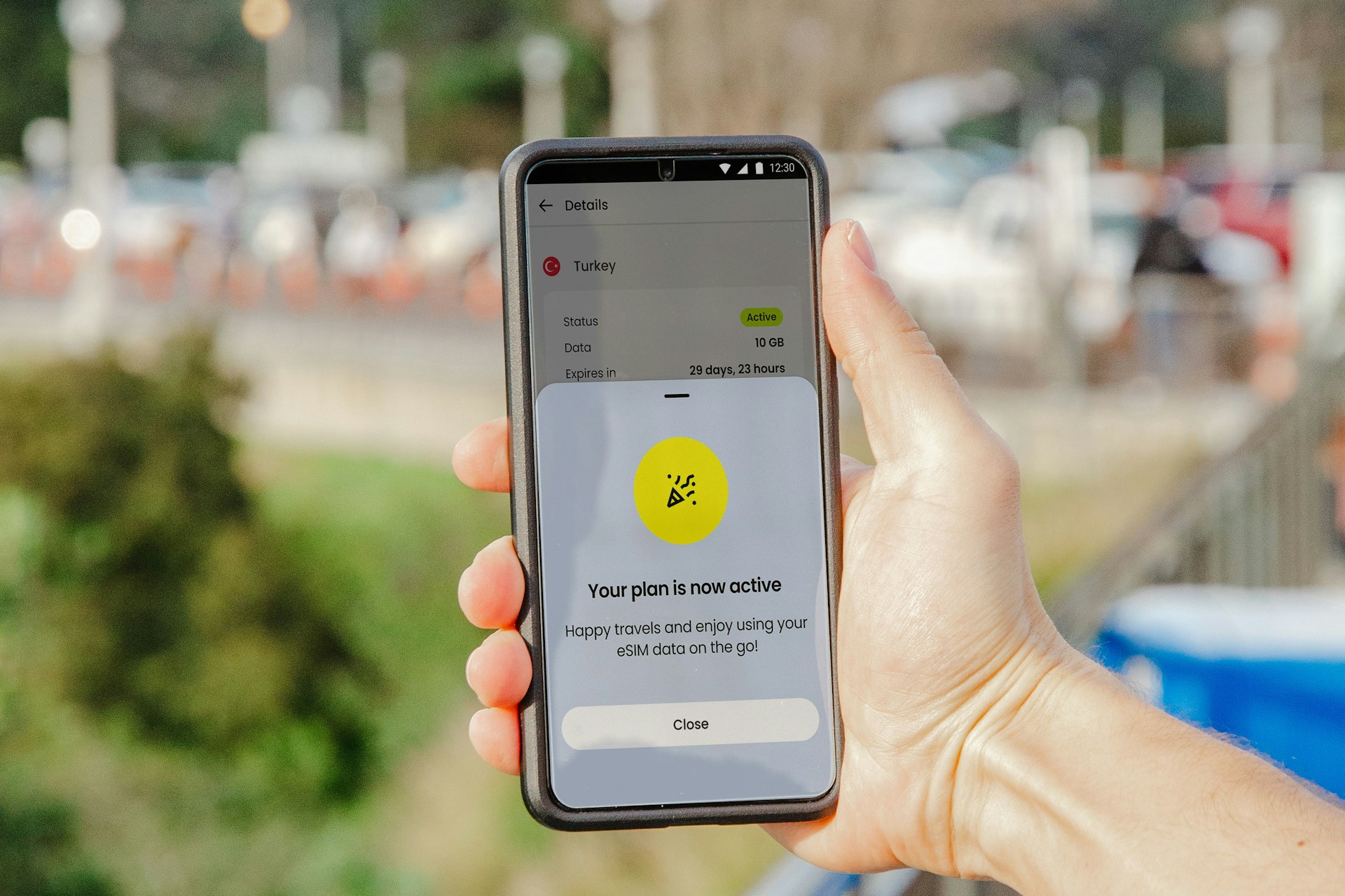 a hand holding a phone saying travel esims