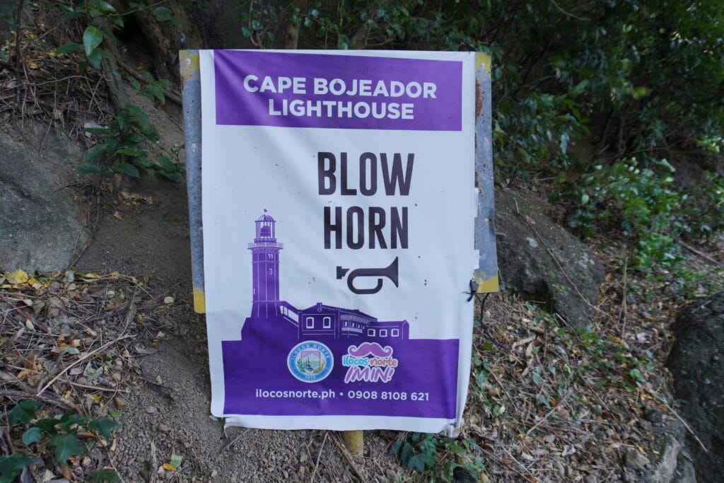 Warning sign at Cape Bojeador Lighthouse in Ilocos Norte showing instructions to blow the horn.