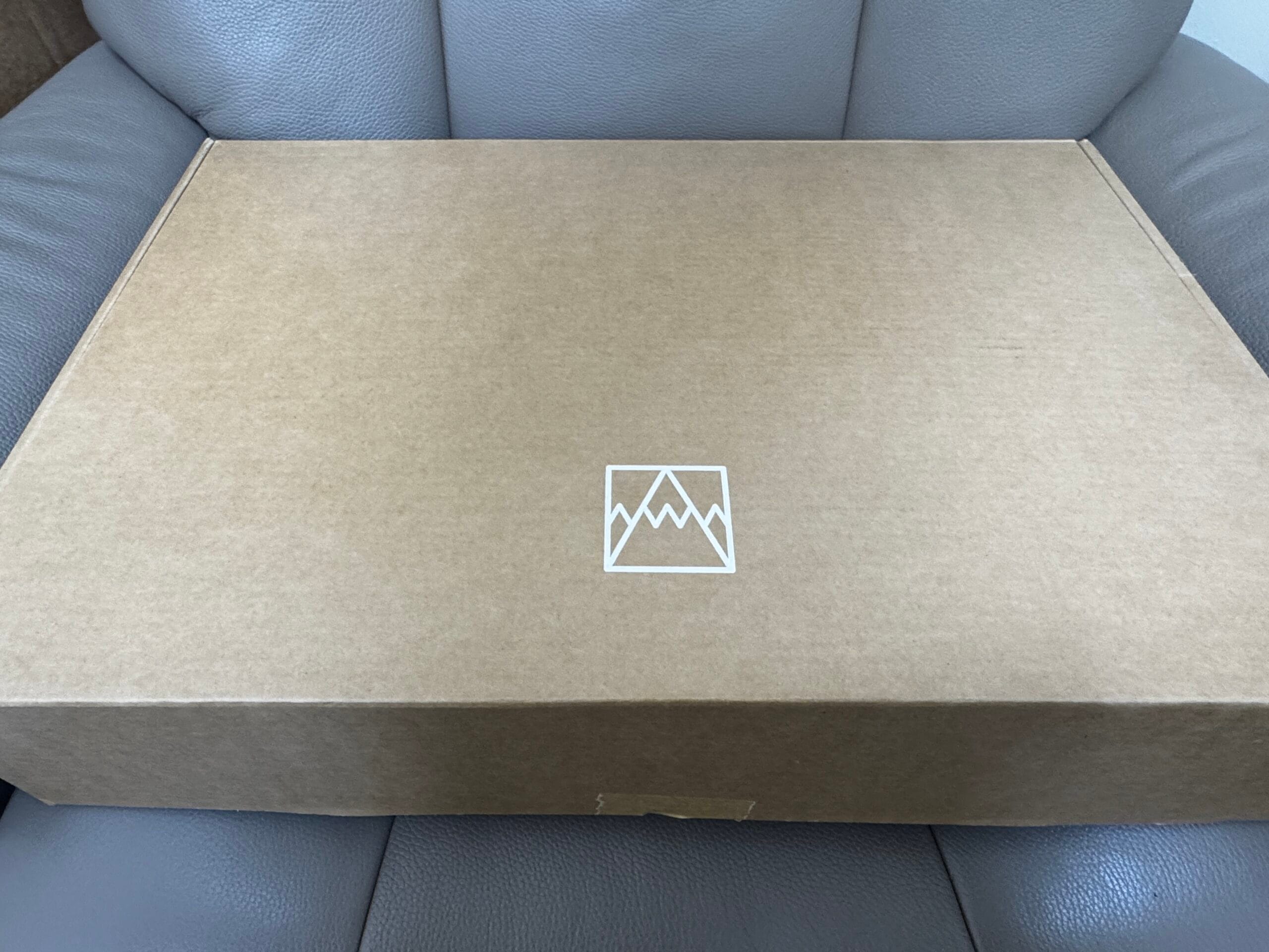 Closed box resting on a chair before opening