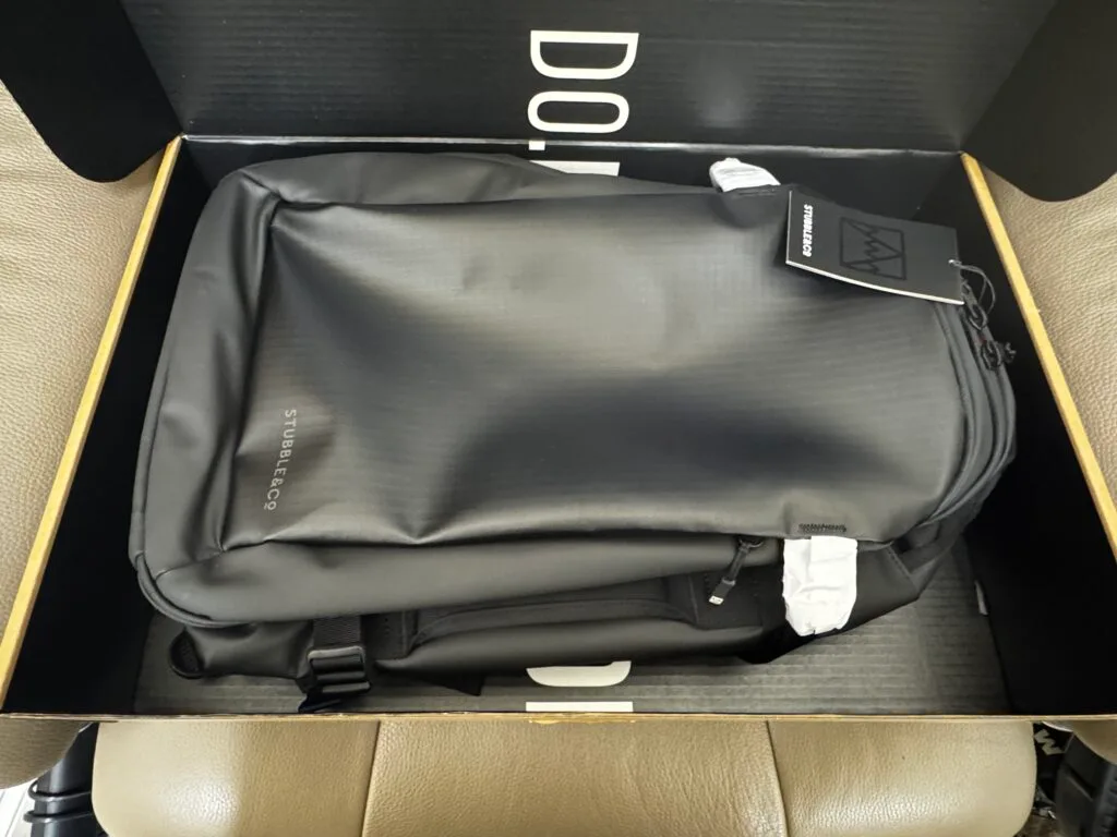 Top view of Stubble and Co backpack inside the box during unboxing with protective packaging