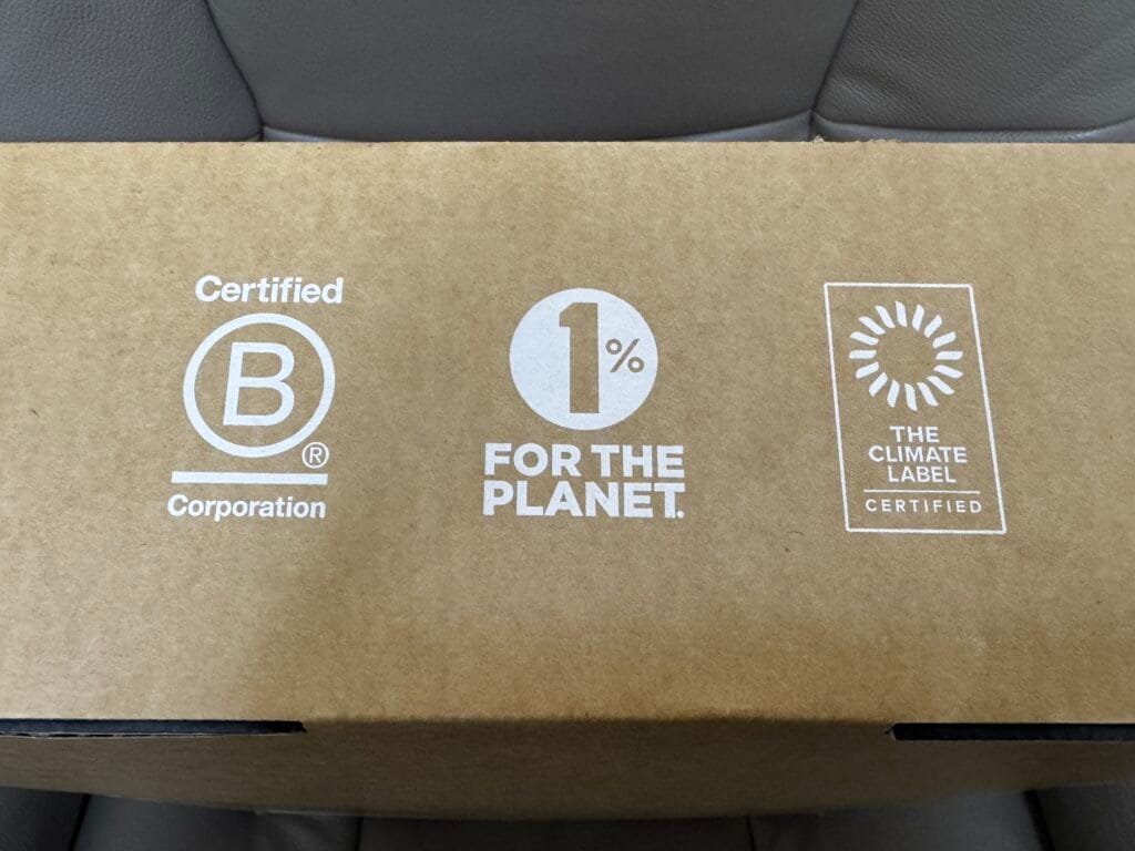 Brand packaging showing B Corp certification, 1 percent for the Planet logo, and The Climate Label certification