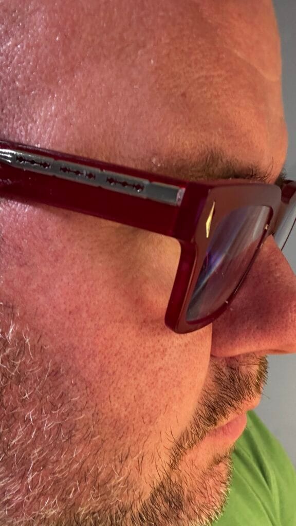 Side profile of unique funky glasses frames with chunky red acetate razor temples