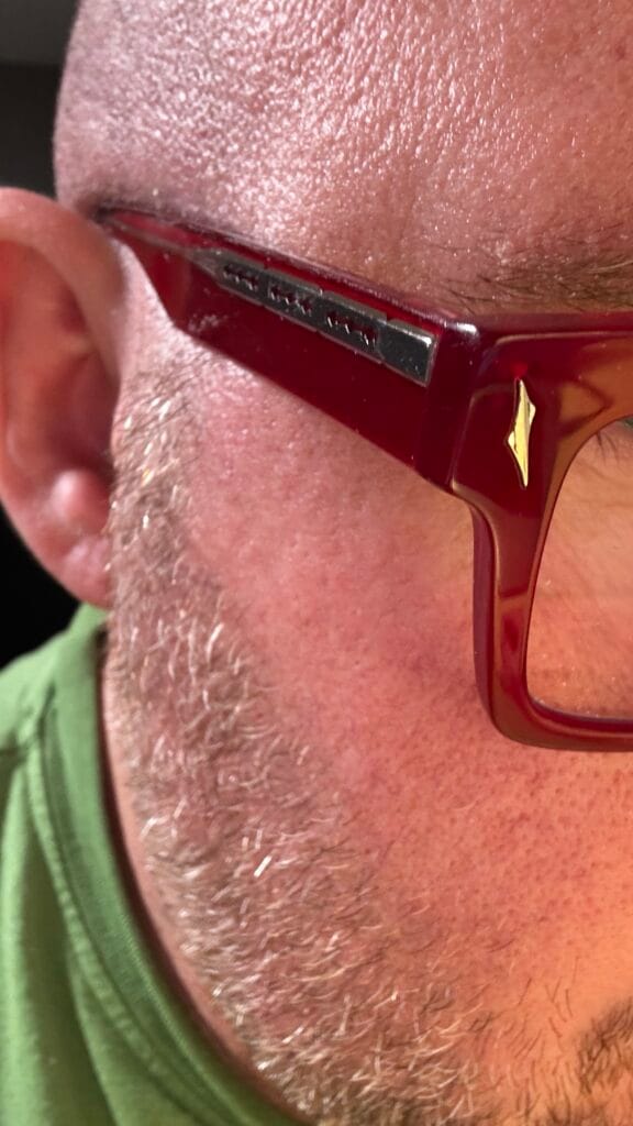 Close-up detail of unique funky glasses frames with decorative razor temple accent