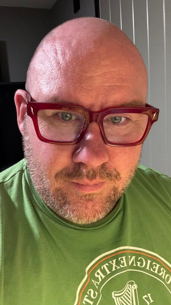 Man wearing unique funky glasses frames by Vooglam in bold red acetate