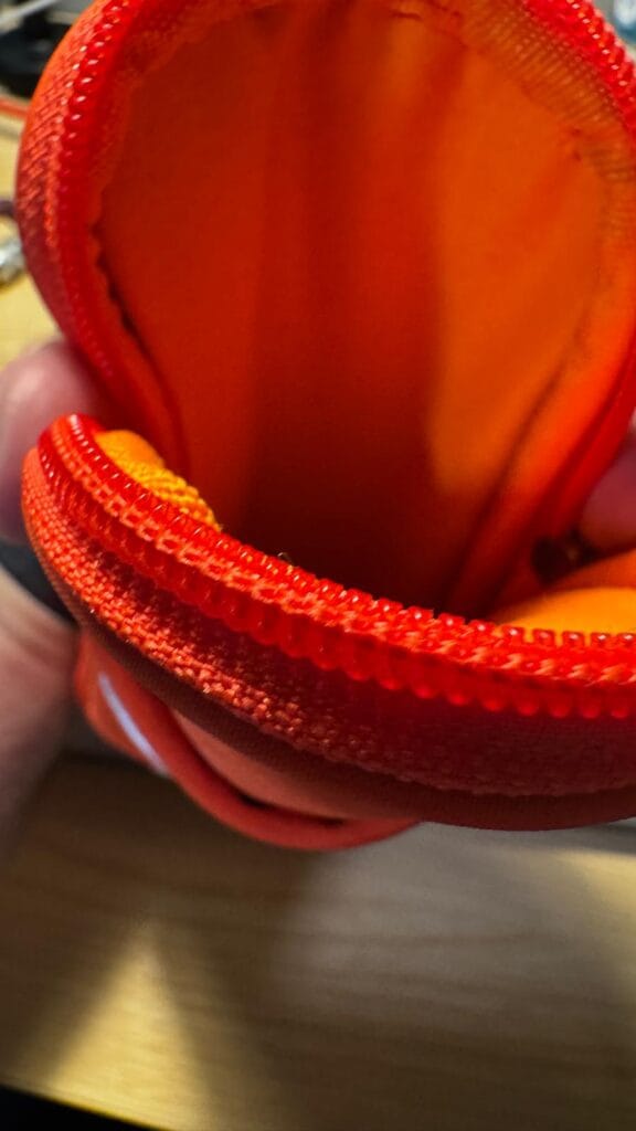 Interior of the red Vooglam crossbody phone bag showing the main storage compartment.