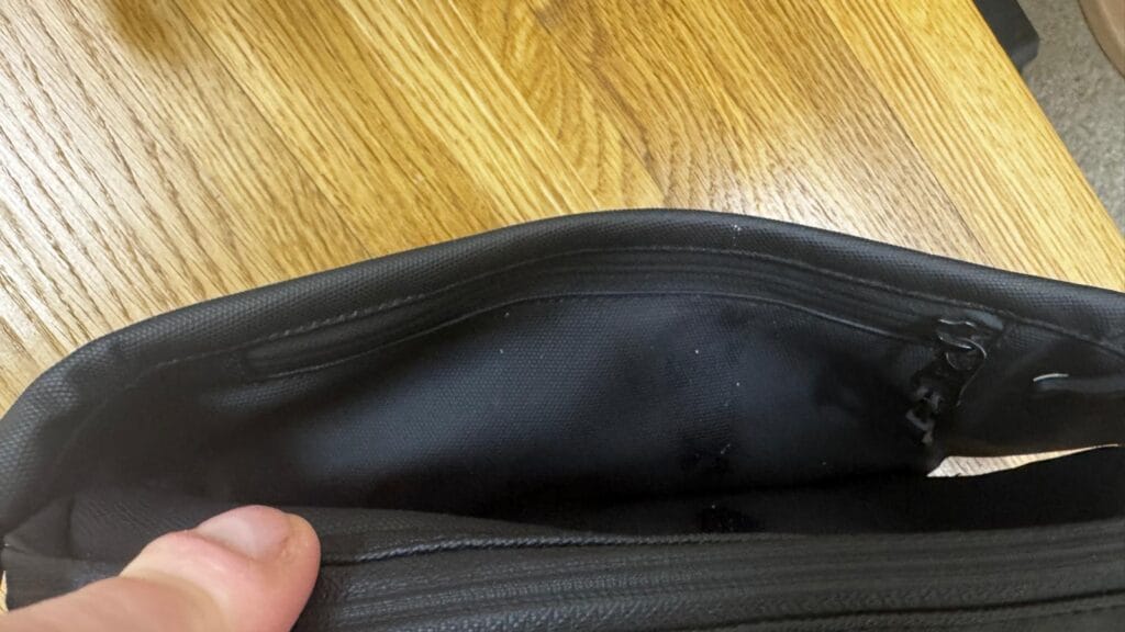 Front internal zip pocket in the Stubble & Co crossbody travel sling bag