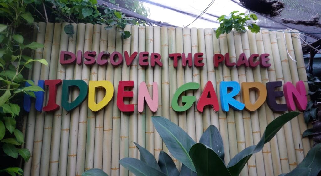 Hidden Garden Vigan “Discover the Place” sign on bamboo wall
