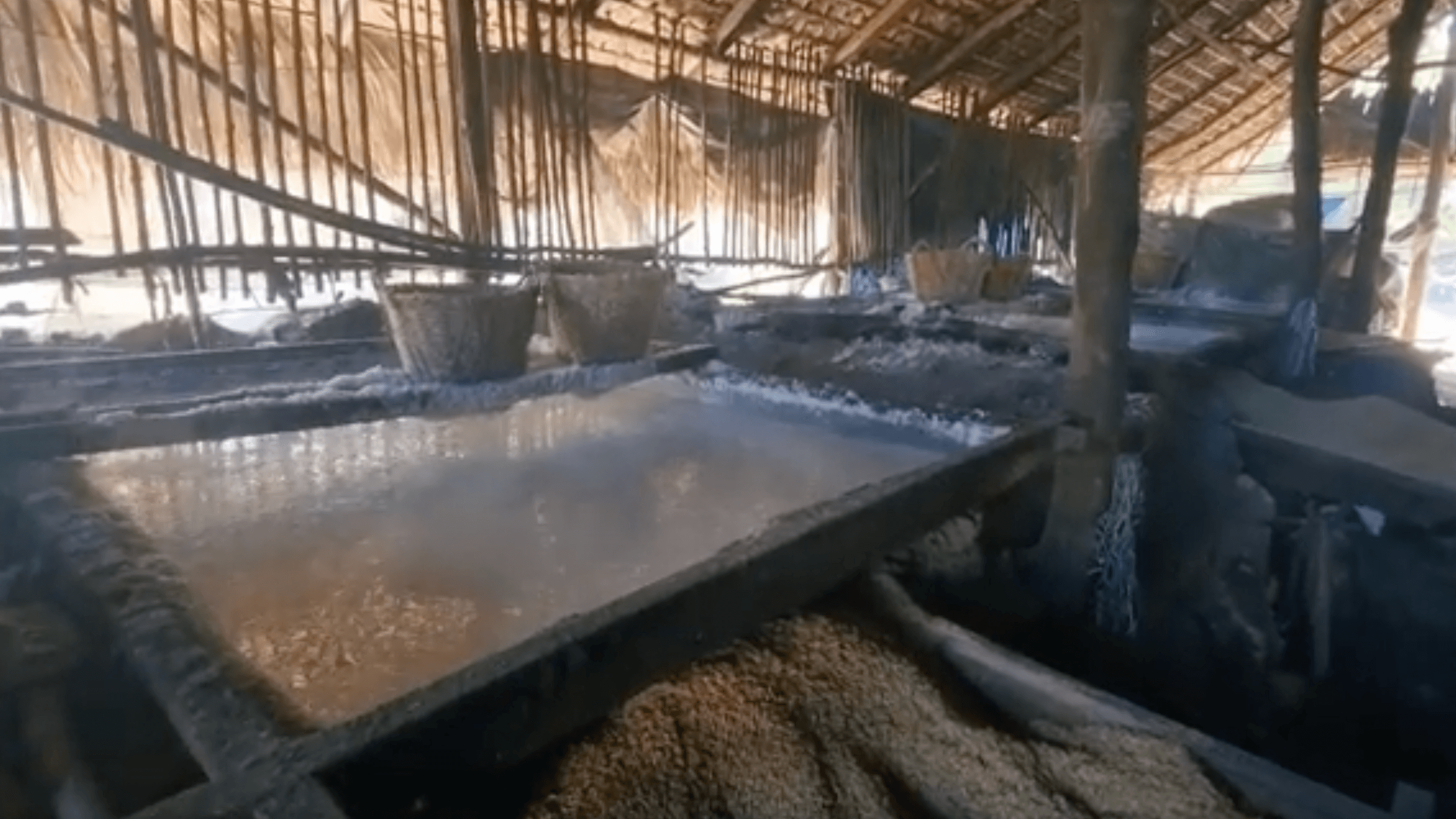Salt making process inside a hut in Pasuquin and Burgos, Ilocos Norte using rice husks and coconut husks to evaporate seawater