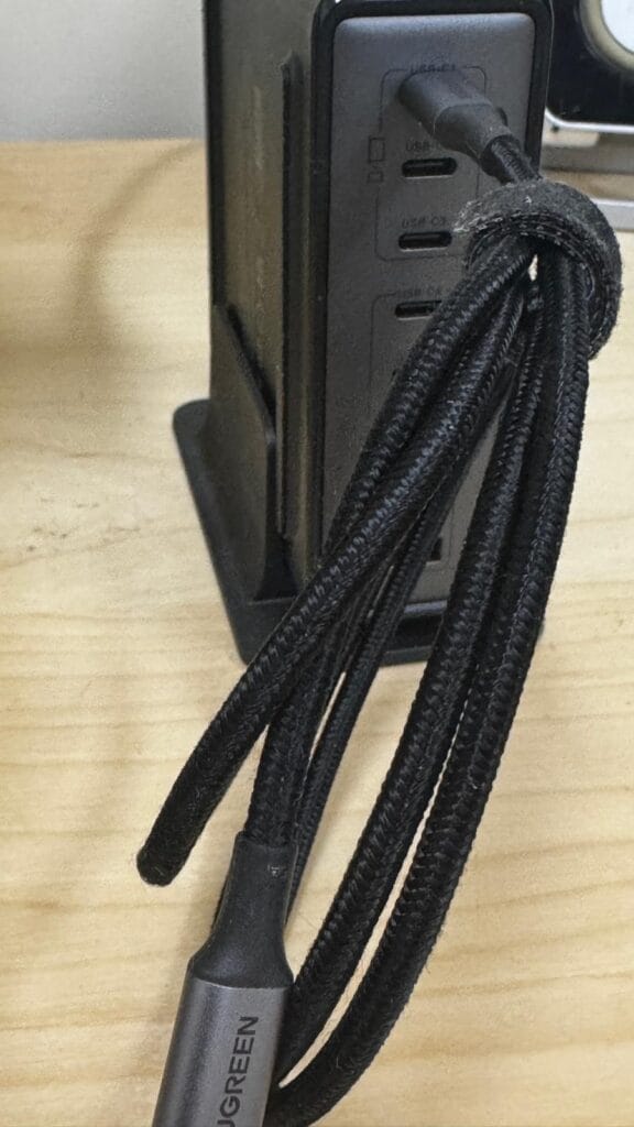Front view of UGREEN 200W multi‑port charging station on desk with braided USB‑C cable