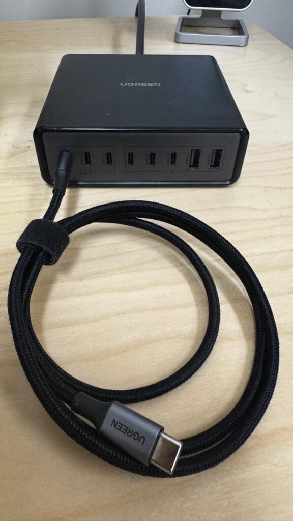 Close-up of UGREEN desktop charging hub ports with connected USB‑C cable