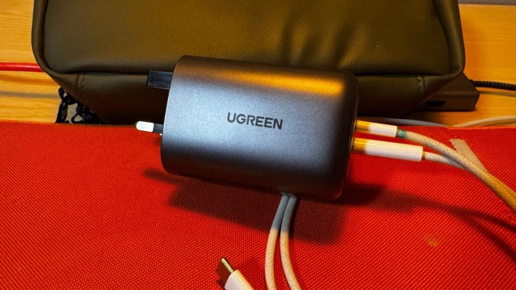 Compact UGREEN USB‑C wall charger shown ready for travel use