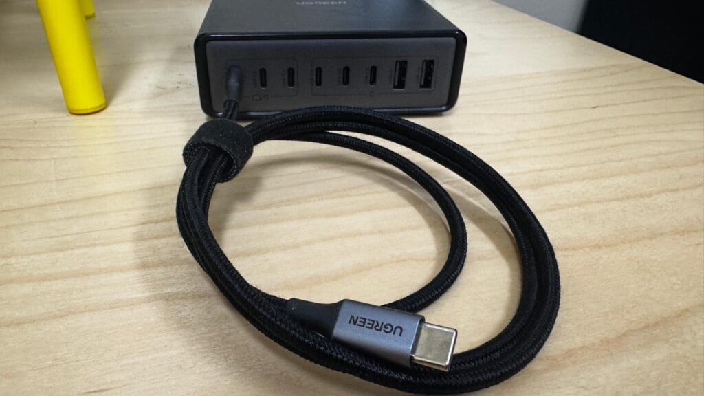 Front view of UGREEN 200W multi‑port charging station on desk with braided USB‑C cable