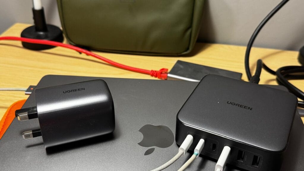 UGREEN multiport GaN charger charging multiple devices on a MacBook desk setup