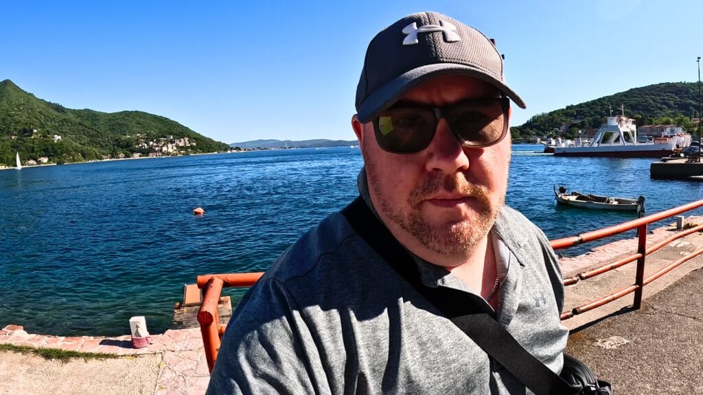 Solo traveller beside the Bay of Kotor during a Montenegro road trip