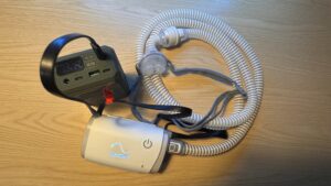 ResMed AirMini running from a travel battery set to 24V, with mask and tubing